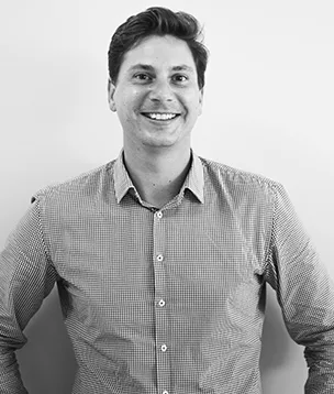 Dexter ten Hoopen of Viridis Development Partners, smiling portrait in a checked shirt