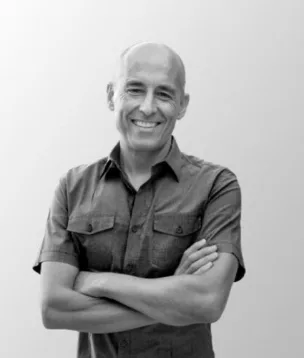 Viridis Development Partners team member, a smiling man with arms crossed in a dark shirt