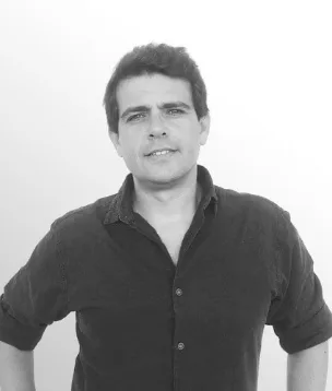 Viridis Development Partners team member in a dark shirt, portrait on a light background