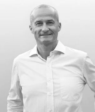 Viridis Development Partners team member in a white dress shirt, smiling portrait